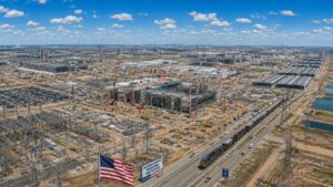 Massive AI infrastructure construction in the United States showing data centers, electrical substations, transmission lines, and semiconductor manufacturing facilities supporting the AI arms race.